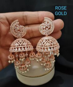 Rose Gold/Silver Diamond Jhumki with mangtika/Indian Jhumka Earring/AD Jhumka/CZ Jhumka/Indian Jewelry/Pakistani Jewelry/Celebrity Earring Also features diamante cz work. Perfect match for them cocktail nights. High quality diamond simulant (Grade AAA), guaranteed to SPARKLE! Each stone is carefully prong set (not glued). Delicate & Elegant design that will make a statement on your special day. The design is distinctive & feminine - absolutely goes with everything. You will continue to enjoy them after your wedding! STYLE TIP - Wear this with pastel dresses, black sarees or indo western silhouettes. Gorgeous Crystal, pearls, Silver & gold finish earrings. Highest quality and craftsmanship, Ready to ship from India  Please contact us any questions Small Jhumka, Barrister Babu, Celebrities Earrings, Necklace Combo, Jewelry Pakistani, Artificial Jewellery, Pakistani Jewelry, Indian Earrings, Jewelry Indian