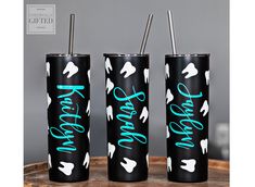 three black tumblers with white horses on them and the words happy new year written in blue ink