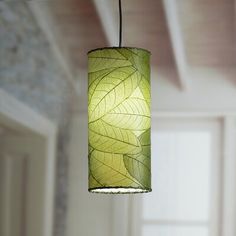 a green lamp hanging from a ceiling in a room