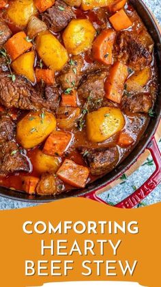 beef stew with carrots and potatoes in a skillet on top of a table