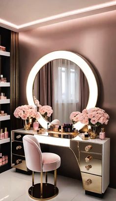 a dressing table with flowers on it in front of a round mirror and pink chairs