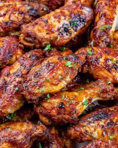 close up of chicken wings with parsley on the top and in the middle, ready to be eaten