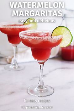 two glasses filled with watermelon margaritas sitting on top of a marble counter