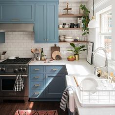 the kitchen is clean and ready for us to use it's blue cabinetry