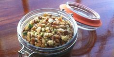 a glass jar filled with food sitting on top of a wooden table