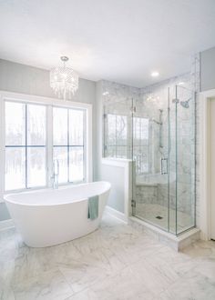 a white bath tub sitting next to a walk in shower