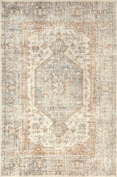 an area rug with various colors and patterns on the floor, including beiges, browns, and blue