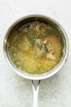 a pot filled with soup sitting on top of a counter