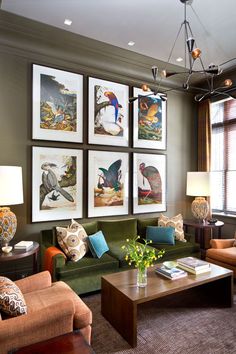 a living room filled with lots of furniture and pictures on the wall above it's coffee table