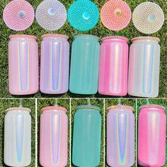 there are many different colored cups on the grass