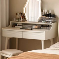 a white dressing table with a mirror, stool and various makeup products on top of it