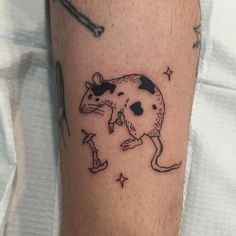 a tattoo on the leg of a man with a mouse and stars around it,