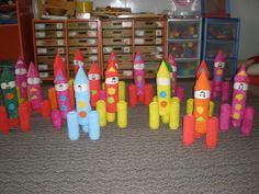 there are many colorful toy rockets on the floor in front of some shelves and bins