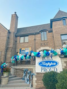 a large building with balloons and decorations on the front door, along with a sign that says bubba's proud