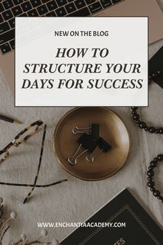 a desk with a laptop, book and other items on it that says how to structure your days for success