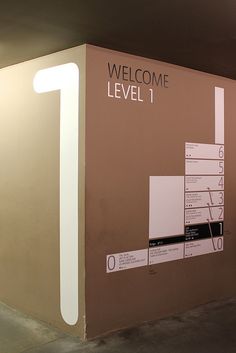 a sign that says welcome level 1 in front of a wall with information on it