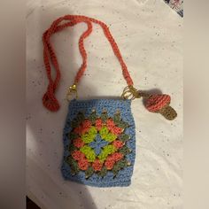 a crocheted purse with a tassel hanging from it