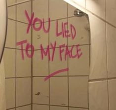 a bathroom mirror with graffiti written on it and the words you led to my face