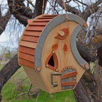 a bird house hanging from a tree branch