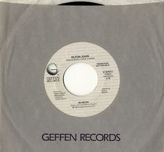 an album cover with the words geffen records in black and white on grey paper