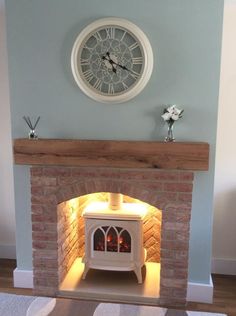 a fireplace with a clock on the wall above it