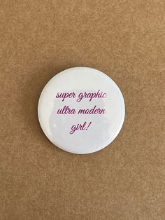 a button that says, super graphic ultra modern girl