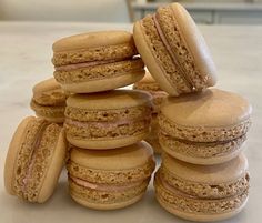 a stack of macaroons sitting next to each other on top of a table