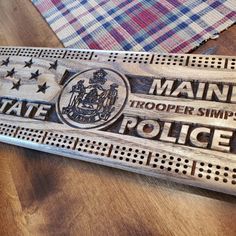 a wooden sign that says maine trooper simpson police