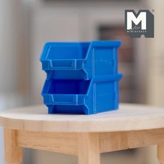 a blue plastic container sitting on top of a wooden table