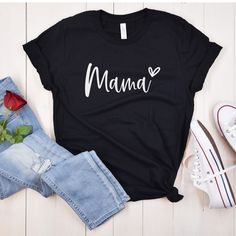 Mama shirt, Mom shirt, Mother's Day gift, Mom gift, Mother's Day shirt, Family shirt, Mom life shirt, Mommy shirt, Motherhood shirt, Mom tee, Mama tee This Mama shirt is the perfect way to show your love for your little ones. Made from high-quality materials, it features a comfortable and stylish design that's perfect for everyday wear. The shirt is available in a range of sizes and colors, making it easy to find the perfect fit for you. Whether you're out running errands or spending quality time with your family, this Mama shirt is sure to become a favorite in your wardrobe. ORDERING 1 - Select size and color 2 - Select garment type (hoodie, crewneck sweatshirt, or t-shirt) 3 - Select quantity  CARE INSTRUCTIONS Wash item inside out in cold water, do not bleach, do not dry clean, do not i Casual Valentine's Day Top With Text Print, Black Relaxed Fit Shirt As Gift, Mother's Day Cotton Slogan Tops, Black Family Matching Shirt For Mother's Day, Valentine's Day Cotton Crew Neck Shirt, Trendy Long Sleeve T-shirt For Mother's Day, Casual Valentine's Day Tops With Letter Print, Casual Letter Print Tops For Valentine's Day, Casual Tops With Letter Print For Valentine's Day