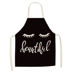 a black apron with eyelashes and the words beautiful written in white letters on it's front