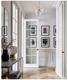 an entry way with pictures on the wall