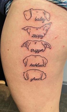 a woman's thigh with three dogs on it