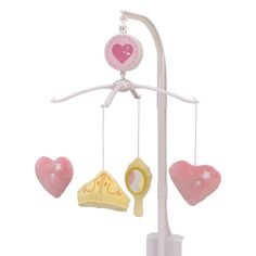 a pink and white baby mobile with hearts hanging from it's sides on a pole