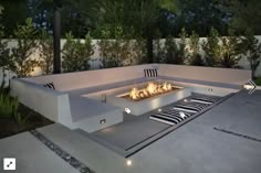 an outdoor fire pit in the middle of a patio