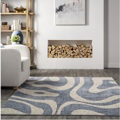 a living room filled with furniture and a firewood log holder on top of a rug