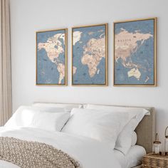 two framed maps on the wall above a bed