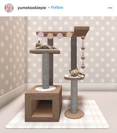 a cat tree with two cats in it and some balls on the wall behind it