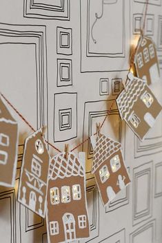 some paper houses are hanging on a string