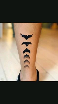 a woman's leg with three birds on it