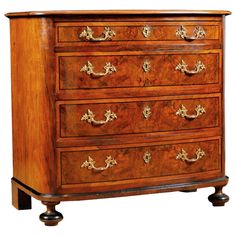 an antique chest of drawers with brass handles