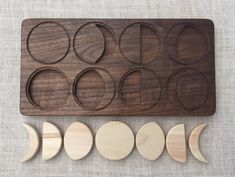 a wooden tray with eight moon phases on it