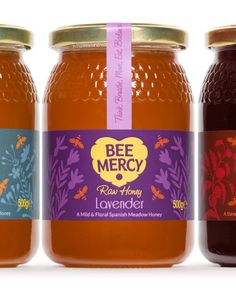 three jars of bee mercy raw honey on a white background with a pink ribbon