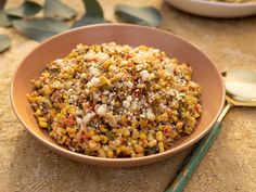 a bowl filled with corn on top of a table