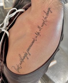 the back of a woman's shoulder with writing on it