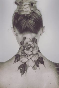 a woman with a flower tattoo on her neck