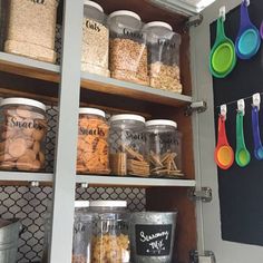 an organized pantry with lots of food and utensils on the shelves next to each other