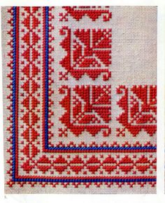 a cross stitch pattern with red and blue trimmings on white fabric, in the shape of a square