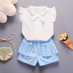 2-piece Ruffle Short Sleeve Shirt & Shorts for Toddler Girl - PrettyKid Blue Cotton Short Set For Summer, Cute Summer Short Set For Playtime, Light Blue Cotton Sets For Summer, Blue Cotton Ruffle Sets, Blue Cotton Ruffled Sets, Summer Blue Short Sets, White Short Set For Playtime In Summer, Light Blue Short Sleeve Sets For Summer, Light Blue Ruffled Sets For Summer