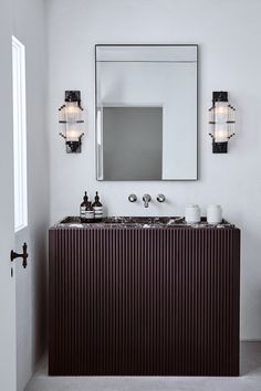 a bathroom with two sinks and a large mirror